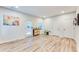 Open living room with white walls, bright lights and wood flooring that leads to an outdoor patio at 399 Se Skylar Way, Atlanta, GA 30315