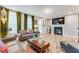 Comfortable living room with a fireplace, large windows, and stylish decor at 399 Se Skylar Way, Atlanta, GA 30315