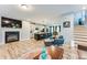 Cozy living room with fireplace, open to kitchen with island seating and dining area at 399 Se Skylar Way, Atlanta, GA 30315