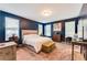 Main bedroom with blue accent wall, carpet floor, multiple windows and a makeup desk at 399 Se Skylar Way, Atlanta, GA 30315