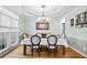 Formal dining room featuring elegant trim, a tray ceiling, and hardwood floors at 4103 Devon Wood Ne Dr, Marietta, GA 30066