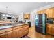 Open kitchen boasts granite counters, stainless refrigerator, and wood cabinets at 4103 Devon Wood Ne Dr, Marietta, GA 30066