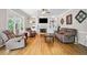 Bright living room with hardwood floors, fireplace, and built-in shelves at 4103 Devon Wood Ne Dr, Marietta, GA 30066
