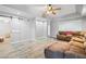 Spacious living room with a large sectional sofa, stylish barn door, and wood-look tile flooring at 4103 Devon Wood Ne Dr, Marietta, GA 30066