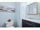 Charming powder room with blue walls, vanity with granite top, and modern fixtures at 4103 Devon Wood Ne Dr, Marietta, GA 30066