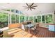 Bright sunroom with a fireplace, wood floors, and large windows offering wooded views at 4103 Devon Wood Ne Dr, Marietta, GA 30066