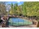 Community tennis court surrounded by trees, offering a private and secluded playing experience at 4103 Devon Wood Ne Dr, Marietta, GA 30066