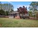 Landscaped backyard with deck, screened porch, grill, wooden fence, and a beautiful red maple tree at 434 Shepard Sw Dr, Marietta, GA 30064
