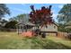 Back of house showcasing the porch, deck, landscaped lawn and mature trees in the backyard at 434 Shepard Sw Dr, Marietta, GA 30064