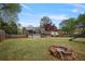 Spacious backyard featuring a fire pit, wooden fence, screened-in porch, and a slide, perfect for outdoor enjoyment at 434 Shepard Sw Dr, Marietta, GA 30064