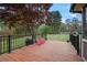 Backyard with a wood deck, fenced-in yard, lush grass, mature landscaping, and playground set at 434 Shepard Sw Dr, Marietta, GA 30064