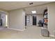 Spacious basement area with neutral carpet, shelving for storage, and direct access to another room at 434 Shepard Sw Dr, Marietta, GA 30064