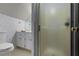 Well-lit bathroom featuring a toilet, patterned wallpaper, vanity with sink, and glass enclosed shower at 434 Shepard Sw Dr, Marietta, GA 30064