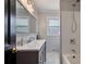 Contemporary bathroom featuring a gray vanity, tub/shower combo, and white subway tile at 434 Shepard Sw Dr, Marietta, GA 30064