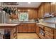 Traditional kitchen with wood cabinets, granite countertops, and stainless steel appliances at 434 Shepard Sw Dr, Marietta, GA 30064