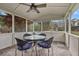 Screened porch featuring a ceiling fan, tiled floor, and glass table with four cushioned chairs at 434 Shepard Sw Dr, Marietta, GA 30064