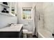 Well-lit bathroom featuring a shower-tub combo, modern fixtures, and a neutral color scheme at 539 Collingwood Dr, Decatur, GA 30032