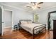 Comfortable bedroom with wood floors, soft lighting, and a metal frame bed at 539 Collingwood Dr, Decatur, GA 30032