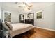 Inviting bedroom with wood floors, large windows, a ceiling fan, and a dresser at 539 Collingwood Dr, Decatur, GA 30032