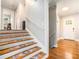 Inviting entryway with hardwood floors, staircase with carpet runner, and natural light at 539 Collingwood Dr, Decatur, GA 30032