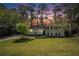 Charming two-story home with a brick facade, landscaped front yard, and driveway with carport at 539 Collingwood Dr, Decatur, GA 30032