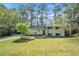 Charming two-story home with a brick facade, landscaped front yard, and driveway with carport at 539 Collingwood Dr, Decatur, GA 30032