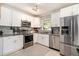 Modern kitchen with white cabinetry, stainless steel appliances, and mosaic tile backsplash at 539 Collingwood Dr, Decatur, GA 30032