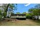 View of the back of the home, featuring dark skirting, light siding, and stairs leading to the yard at 1076 Fairburn Nw Rd, Atlanta, GA 30331