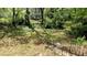 Secluded backyard view with mature trees and greenery, accessible by stairs leading into the yard at 1076 Fairburn Nw Rd, Atlanta, GA 30331