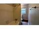 Clean bathroom with a tiled shower, window, and neutral tones at 1076 Fairburn Nw Rd, Atlanta, GA 30331
