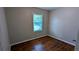 Cozy bedroom with a window and original hardwood flooring at 1076 Fairburn Nw Rd, Atlanta, GA 30331