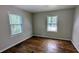 Comfortable bedroom featuring two windows and hardwood floors at 1076 Fairburn Nw Rd, Atlanta, GA 30331