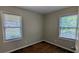 Bedroom featuring two windows and original hardwood floors at 1076 Fairburn Nw Rd, Atlanta, GA 30331