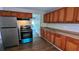 Functional kitchen with wood cabinets, laminate floors, and stainless steel refrigerator at 1076 Fairburn Nw Rd, Atlanta, GA 30331
