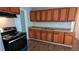 Functional kitchen with wood cabinets, laminate floors, and black range at 1076 Fairburn Nw Rd, Atlanta, GA 30331