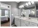 Well-lit bathroom featuring double sink vanity with white cabinets and large mirror at 3673 Madison St, Atlanta, GA 30337