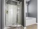Bright bathroom with glass shower, soaking tub, neutral finishes, and modern fixtures at 3673 Madison St, Atlanta, GA 30337