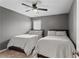 Bedroom featuring two beds with neutral colors and decor, and a ceiling fan at 3673 Madison St, Atlanta, GA 30337