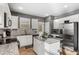 Modern kitchen with white cabinets, granite counters, and stainless steel appliances at 3673 Madison St, Atlanta, GA 30337