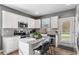 Well-lit kitchen with white cabinets, modern appliances, and granite countertops at 3673 Madison St, Atlanta, GA 30337