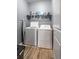 Functional laundry room features newer washer and dryer set and shelving for optimal organization at 3673 Madison St, Atlanta, GA 30337