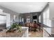 Open concept living area with wood floors, fireplace, dining area, and abundant natural light at 3673 Madison St, Atlanta, GA 30337
