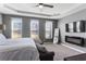 Spacious bedroom featuring neutral carpet, modern fireplace, large wall mounted TV, and natural lighting at 3673 Madison St, Atlanta, GA 30337
