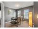 Office space featuring a desk, two chairs, natural light and a unique floor lamp at 3673 Madison St, Atlanta, GA 30337
