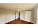 A bedroom with light walls, wood floors and a sliding barn door at 3915 Dahlonega Hwy, Cumming, GA 30028