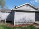 Rear view of a well-maintained home with gray siding, a wooden deck, and a satellite dish mounted on the roof at 3915 Dahlonega Hwy, Cumming, GA 30028
