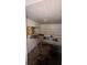 Functional storage room featuring built-in shelves, a fold-down table, and a concrete floor at 3915 Dahlonega Hwy, Cumming, GA 30028
