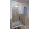 Bathroom shower with glass door and beige tile surround at 5317 Radford Loop, Fairburn, GA 30213