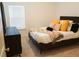 This is a cozy bedroom with a bed, pillows, and a dresser at 5317 Radford Loop, Fairburn, GA 30213