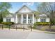 Clubhouse exterior with white columns, black shutters, and landscaped grounds at 5317 Radford Loop, Fairburn, GA 30213
